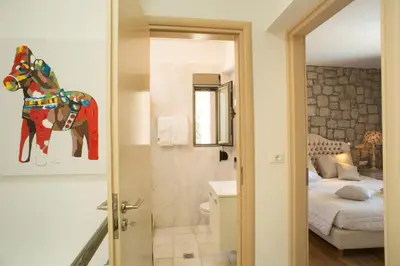 a room with a bathroom with a horse statue in it at Executive Rhodes Villa Villa Althea 2 Bedroom Villa With Sea Views Pefkos in Pefki Rhodes