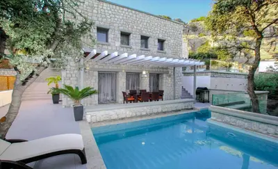 a swimming pool in the backyard of a house at Executive Rhodes Villa Villa Barbie 2 Bedroom With Sea Views Pefkos in Pefki Rhodes