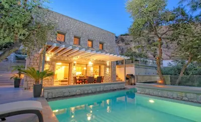 a house with a swimming pool in front of a house at Executive Rhodes Villa Villa Barbie 2 Bedroom With Sea Views Pefkos in Pefki Rhodes