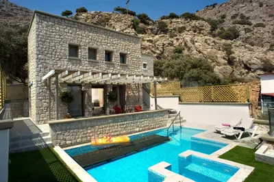 a villa with a swimming pool and a house at Executive Rhodes Villa Villa Ellie 2 Bedroom Villa With Sea Views Pefkos in Pefki Rhodes