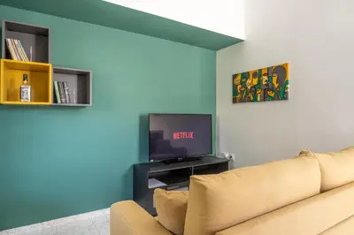 a living room with a couch and a tv at Gitonia Residence - Islander's Home Collection in Rhodes Town