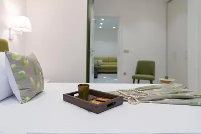 a wooden box sitting on a bed with a chain at Serenity Villas in Kolimbia