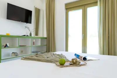 a room with a bed with a tray of food on it at Serenity Villas in Kolimbia