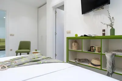 a bedroom with a bed and a green shelf at Serenity Villas in Kolimbia