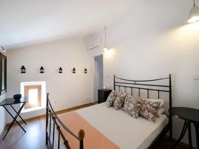 a bedroom with a bed and a table in it at Deluxe Rhodes Villa Villa Sokaki Well Furnished 2 Bedrooms in Líndos