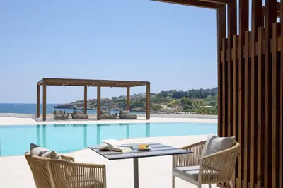 a patio with a table and chairs next to a pool at Ella Elissa - Adults Only in Kallithea Rhodes