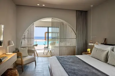 a bedroom with a bed and a balcony with the ocean at Ella Elissa - Adults Only in Kallithea Rhodes