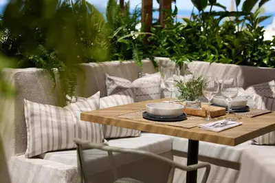 a wooden table with glasses and plates on it at Ella Elissa - Adults Only in Kallithea Rhodes