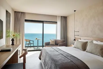 a bedroom with a bed and a view of the ocean at Ella Helea in Kallithea Rhodes