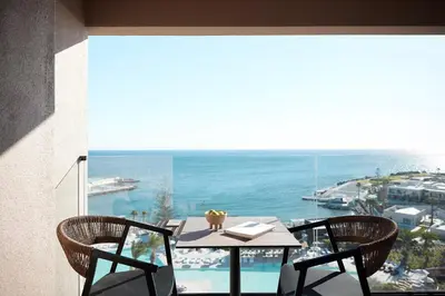 a table and chairs on a balcony with a view of the ocean at Ella Helea in Kallithea Rhodes
