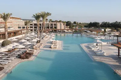 a pool with chairs and umbrellas at a resort at Ella Helea in Kallithea Rhodes