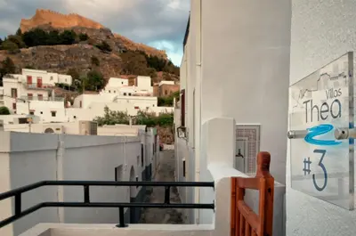 a view of a town from a balcony of a building at Villa Thalassa Suites 3 Modern Comfort Traditional Greek Charm in Líndos