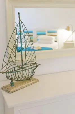 a model of a boat sitting on a counter at Villa Thalassa 2 Cozy Greek Comfort Private Shaded Courtyard in Líndos