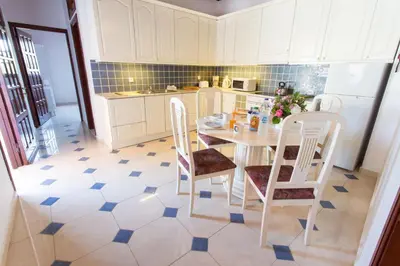 a kitchen with a table and chairs and a refrigerator at Villa Thalassa 2 Cozy Greek Comfort Private Shaded Courtyard in Líndos
