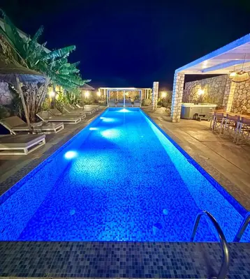 a large swimming pool at night with lights on it at Lindos Villa Aqua Euphoria ex Natura in Líndos