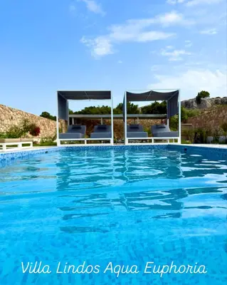 a swimming pool in a villa with blue water at Lindos Villa Aqua Euphoria ex Natura in Líndos