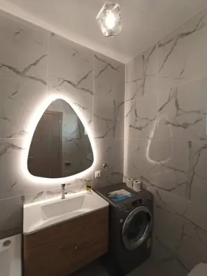 a bathroom with a sink and a washing machine at Lindos Villa Aqua Euphoria ex Natura in Líndos