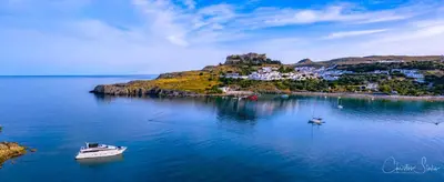 an island with a boat in the water at Lindos Villa Aqua Euphoria ex Natura in Líndos