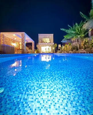 a large swimming pool at night at Lindos Villa Aqua Euphoria ex Natura in Líndos