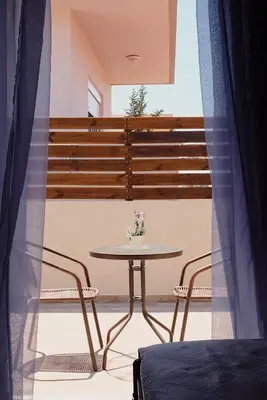 a table and chairs in a room with a window at Casa di Famiglia Rhodes in Koskinou