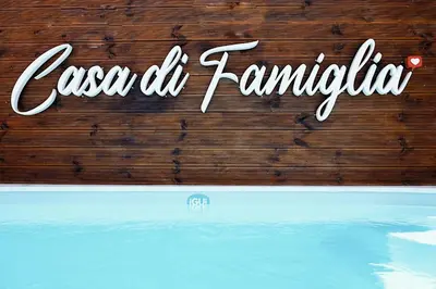 a sign for a swimming pool with the words casa de karma at Casa di Famiglia Rhodes in Koskinou
