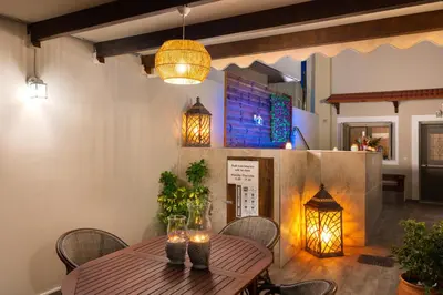 a wooden table with chairs and lights in a room at Casa di Famiglia Rhodes in Koskinou