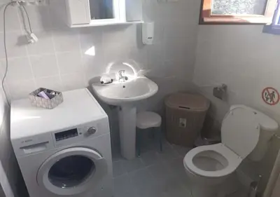 a bathroom with a washing machine and a sink at Symi Breeze villa in Symi