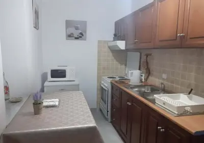a kitchen with a sink and a stove top oven at Symi Breeze villa in Symi
