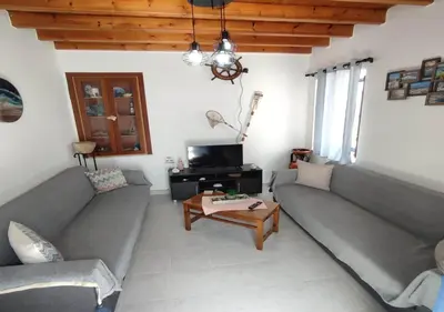 a living room with two couches and a coffee table at Symi Breeze villa in Symi