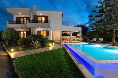 a villa with a swimming pool in front of a house at Villa Vergio in Afantou