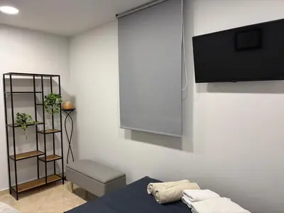a room with a flat screen tv on a wall at Villa Vergio in Afantou