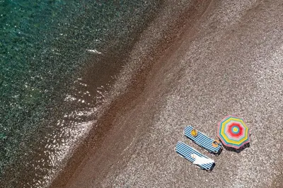 an overhead view of two umbrellas on the ground at Tselios Apartments & Studios in Kiotari