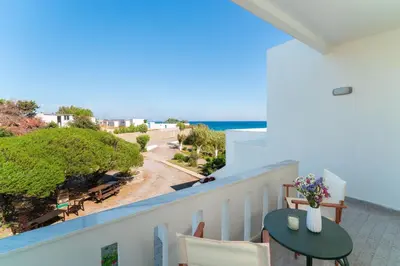 a balcony with a table and a view of the ocean at Tselios Apartments & Studios in Kiotari