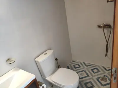 a bathroom with a white toilet and a sink at villa Zinovia in Líndos