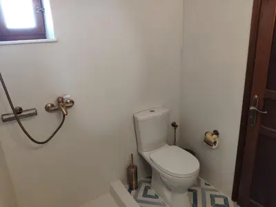 a bathroom with a white toilet in a room at villa Zinovia in Líndos