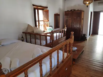 a bedroom with a bed and a stairway with at villa Zinovia in Líndos