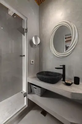 a bathroom with a black sink and a mirror at Anemos Villas in Lachania