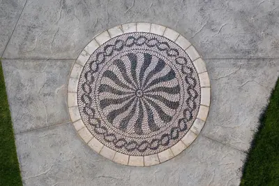 an overhead view of a mandala rug on a sidewalk at Anemos Villas in Lachania
