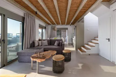 a living room with a couch and a table at Anemos Villas in Lachania