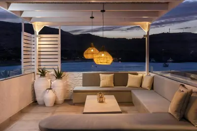 a living room with a couch and a view of the water at Thalassa Luxury Studios Lindos in Líndos