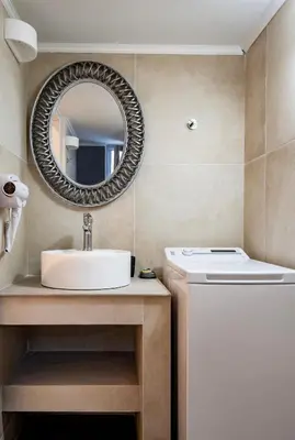 a bathroom with a sink and a mirror at Thalassa Luxury Studios Lindos in Líndos
