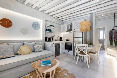 a living room with a couch and a table at Thalassa Luxury Studios Lindos in Líndos