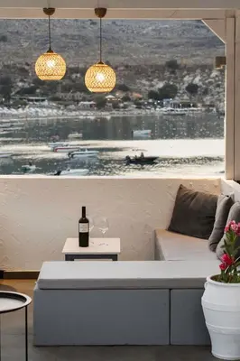 a living room with a couch and a window at Thalassa Luxury Studios Lindos in Líndos