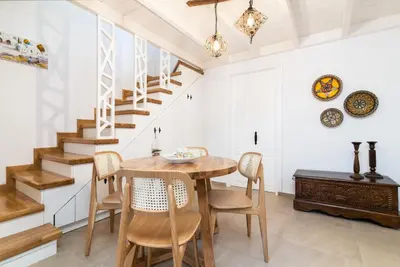 a dining room with a wooden table and chairs at Casa Plumeria of Old Town Rhodes in Rhodes Town