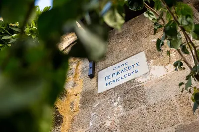 a sign on the side of a brick wall at Casa Plumeria of Old Town Rhodes in Rhodes Town