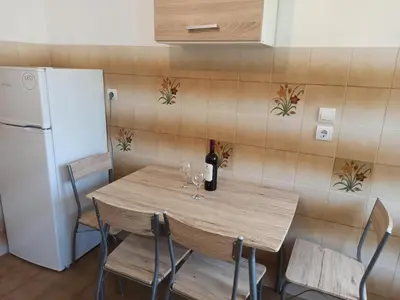a table with a bottle of wine and glasses on it at CHAMBRE ORANGE in Ialyssos