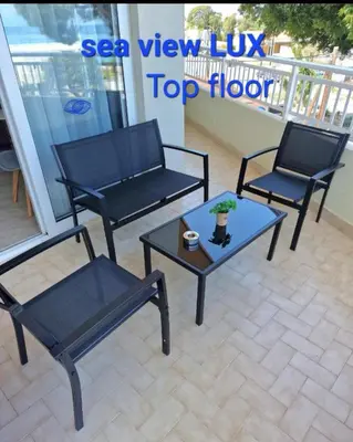 two chairs and a coffee table on a patio at BLUE EYES APARTMENTS in Ixia
