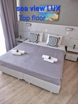 a bedroom with a bed with a top floor at BLUE EYES APARTMENTS in Ixia