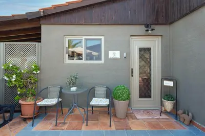 a patio with a table and chairs and a door at Aelia Sea View Bungalow in Gennadi