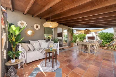 a living room with a couch and a table at Ilaira Sea View Bungalow in Gennadi